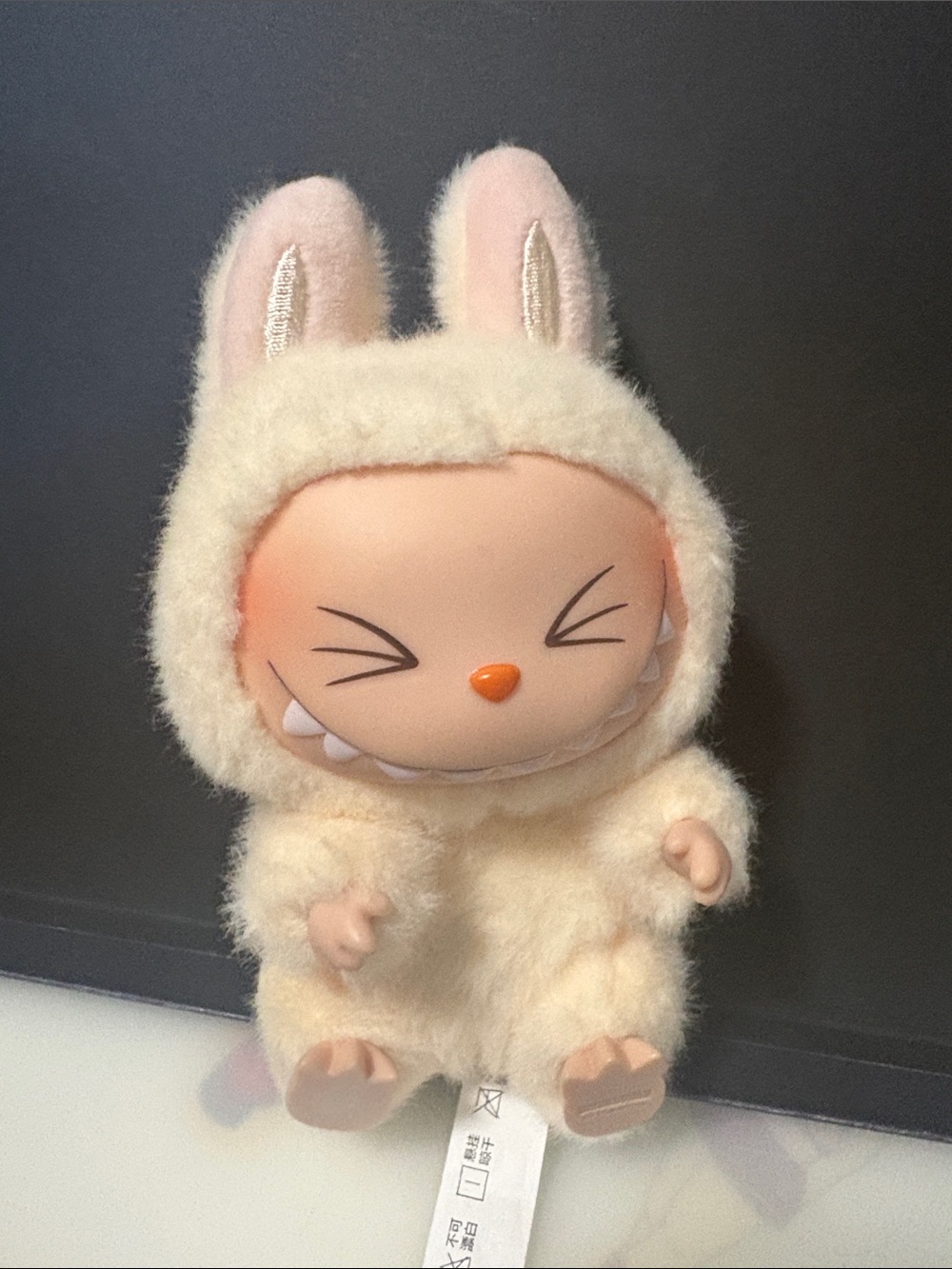 Labubu in the light creme color
